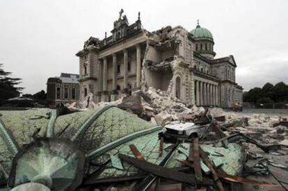 Los escombros cubren un vehículo frente a la catedral católica de Christchurch.