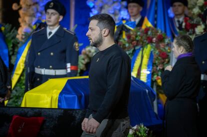 Ukrainian President Volodymyr Zelenskyy pays his respects to victims of a deadly helicopter crash during a farewell ceremony in Kyiv, Ukraine, Saturday, Jan. 21, 2023.