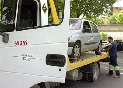 Una grúa cordobesa carga un coche accidentado, después de que ayer se desconvocaran los paros en dicha provincia.
