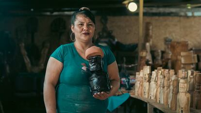 Ana Miraji, an incarcerated woman, with one of the pieces that she produced in the crafts workshop at the prison on Easter Island.