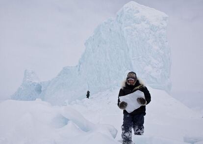 Inuits seccionan trozos de hielo de un gran iceberg en Pond Iniet (Canada), para conseguir agua fresca para beber. La imagen ha logrado el premio de los lectores de Nathional Geographic, dentro de la categoría 'Lugares'.