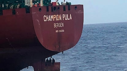 Three migrants sit on top of a rudder on a Norwegian tanker on October 6.