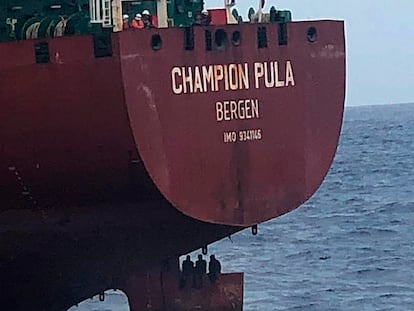 Three migrants sit on top of a rudder on a Norwegian tanker on October 6.