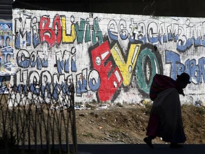 Una boliviana pasea frente a una pintada en apoyo a Morales.