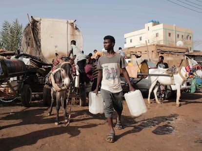 People gather to collect water in Khartoum, Sudan, on May 28, 2023.