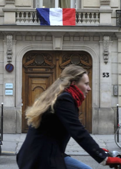 El presidente de Francia, François Hollande, invitó a sus conciudadanos a engalanar con la tricolor las fachadas de sus casas, con motivo del homenaje nacional a las víctimas del 13-N. En la imagen, una mujer en bicicleta pasa junto a un edificio en París.