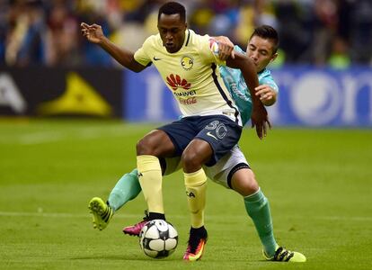 Renato Ibarra (i) del Club América cubre el balón ante la presión de Efraín Velarde de León