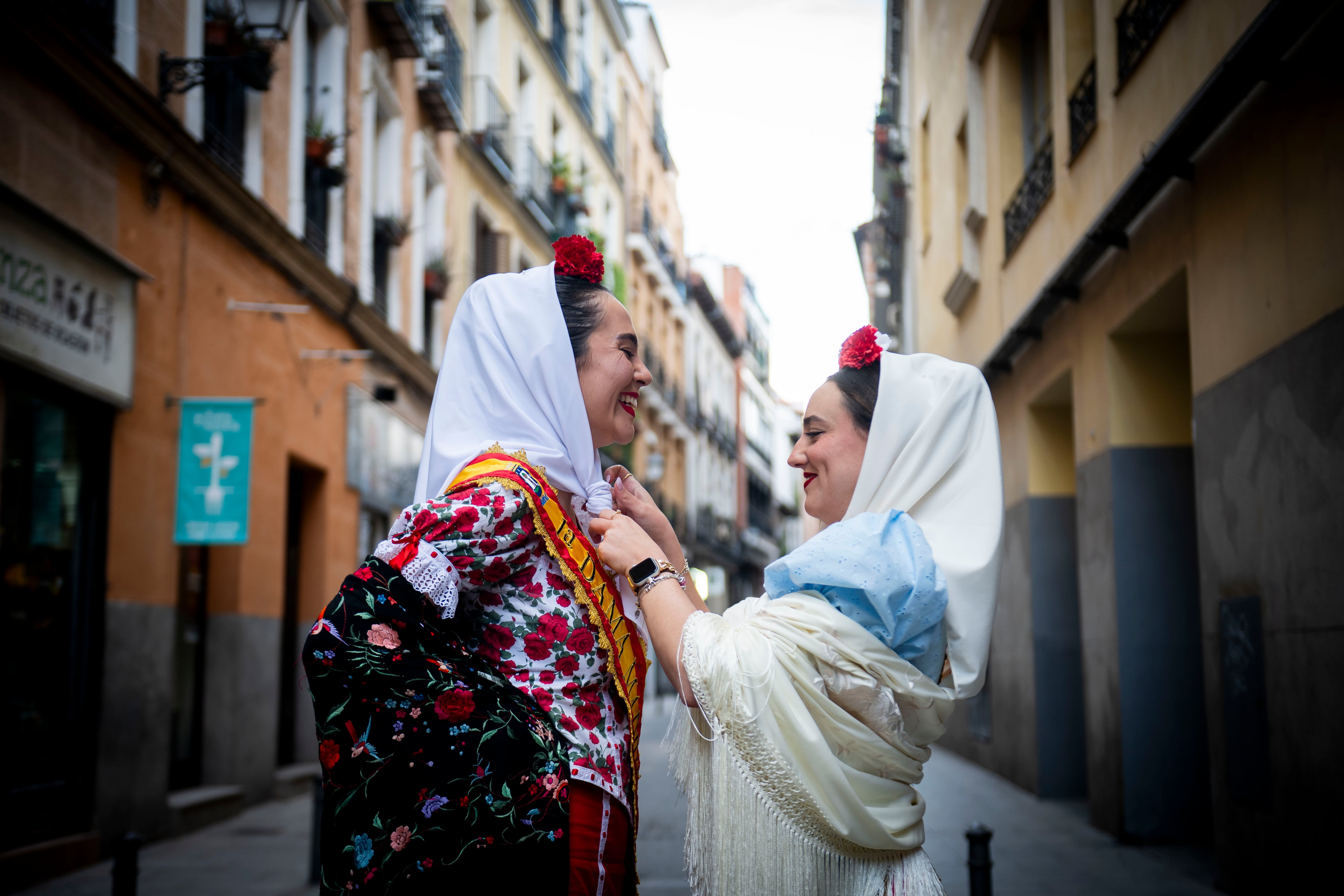 Verónica Vaquero y Teresa Alcaraz se arreglan el traje en la calle de las Dos Hermanas, en el centro de Madrid. 