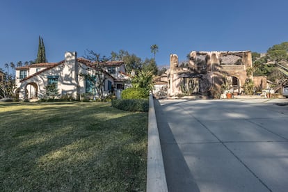 Two neighboring homes, one intact and the other destroyed by the Eaton fire, in Altadena, Los Angeles County, California, on January 11, 2025.