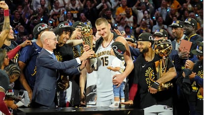 NBA commissioner Adam Silver presents Denver Nuggets center Nikola Jokic (15) the Bill Russell NBA Finals MVP Award after winning the 2023 NBA Finals against the Miami Heat at Ball Arena.