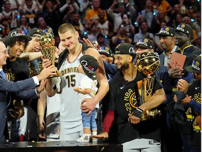 NBA commissioner Adam Silver presents Denver Nuggets center Nikola Jokic (15) the Bill Russell NBA Finals MVP Award after winning the 2023 NBA Finals against the Miami Heat at Ball Arena.