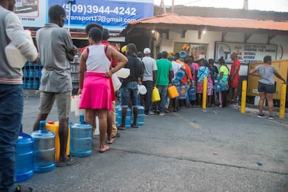 Tras ocho días de violentas protestan, el pais está paralizado y los haitianos están saliendo a las calles en busca de agua y comida. El pasado jueves el presidente lanzó un mensaje a la nación, llamando al diálogo y expresó su solidaridad con las víctimas de las protestas. Moïse, cuya dimisión reclama una parte de la oposición, aseguró que no dejará el país "en manos de bandas armadas y narcotraficantes", que quieren utilizar la empobrecida nación para sus intereses personales. El Sector Democrático y Popular que promueve las manifestaciones, se ha defendido de las acusaciones del presidente afirmando que la oposición no tiene "brazo armado" y que la presencia de individuos armados en las masivas manifestaciones del pasado miércoles es resultado del colapso del Estado. En la foto, decenas de personas se aprovisionan con agua, el 14 de febrero de 2019, en Puerto Príncipe.