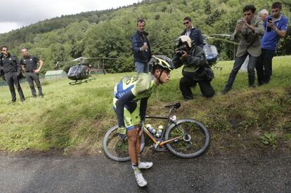 Contador holds his knee after crashing on Monday.