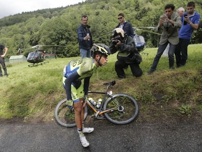 Contador holds his knee after crashing on Monday.