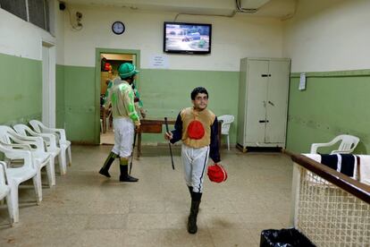 Jockey, Mohammad Hassan, known as Sisi walks across a room at Beirut Hippodrome, Lebanon, April 30, 2017. REUTERS/Jamal Saidi  SEARCH "SAIDI HIPPODROME" FOR THIS STORY. SEARCH "WIDER IMAGE" FOR ALL STORIES.