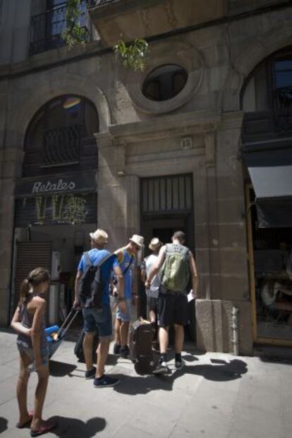 Un grup de turistes entra en un edifici del barri Gòtic.