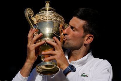 Serbia's Novak Djokovic celebrates with the trophy after beating Australia's Nick Kyrgios in the final of the men's singles on day fourteen of the Wimbledon tennis championships in London, Sunday, July 10, 2022. (AP Photo/Kirsty Wigglesworth)