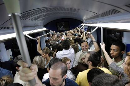 Pasajeros en un vagón abarrotado en la estación de Príncipe Pío. 