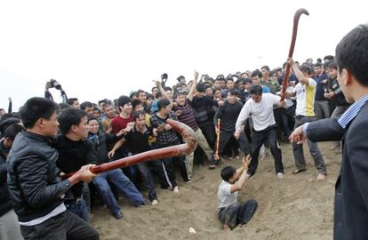 Aldeanos compiten para encontrar una bola roja escondida en la arena durante la tradicional ceremonia de Hoi Phet en el pueblo de Hien Quan, a 100 kilómetros al norte de Hanói (Vietnam). 