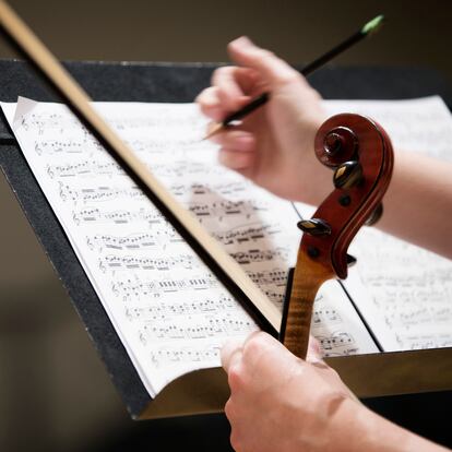 Close up of student writing on sheet music
