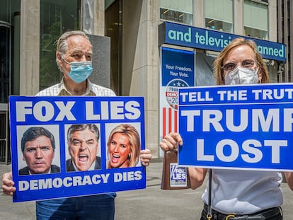Participants seen holding signs at the protest against Fox News.