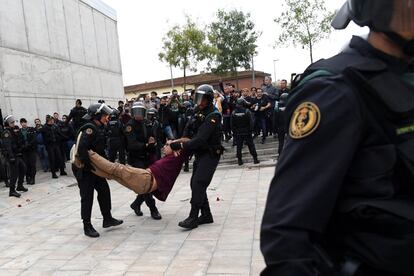 Um homem é desalojado à força por policiais, que evitavam a abertura dos colégios para a votação no referendo independentista.