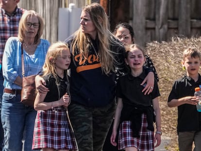 Children and a woman depart the reunification center at the Woodmont Baptist church after a school shooting, on March 27, 2023, in Nashville, Tennessee.