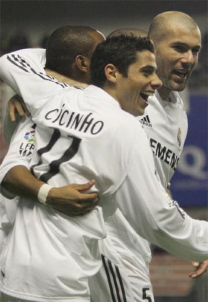 Cicinho y Zidane abrazan a Robinho tras el gol de este último.
