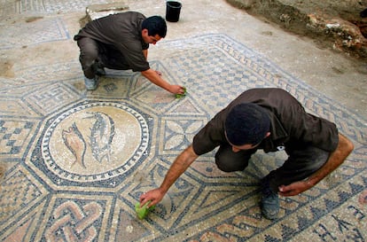 Prisoners work at a nearly 1,800-year-old decorated floor from an early Christian prayer hall discovered by Israeli archaeologists on Sunday, November 6, 2005