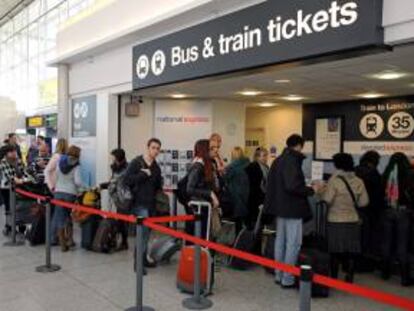 Pasajeros hacen cola para comprar billetes de autobús y tren, después de que sus vuelos se vieran cancelados, en el aeropuerto de Standsted, cerca de Londres (Reino Unido). EFE/Archivo