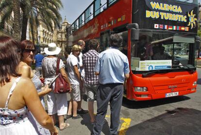 Un grupo de turistas en Valencia a punto de subirse al autobús que les mostrará la ciudad.