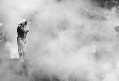 Una Madre de Plaza de Mayo se cubre de los gases lacrimógenos durante la represión policial de las protestas por la crisis de 2001.