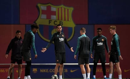 Busquets gesticula com companheiros em treino do Barcelona.