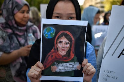 Una joven sostiene una pancarta durante una manifestación de miembros de la comunidad afgana frente a la embajada de Estados Unidos en Atenas después de que los talibanes llegaran al poder en Afganistán el 28 de agosto de 2021.
