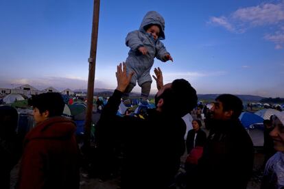 Un padre juega con su hijo en Idomeni.