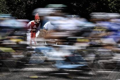 Un hombre disfrazado de cura anima a los corredores de la 104ª edición del tour de Francia.