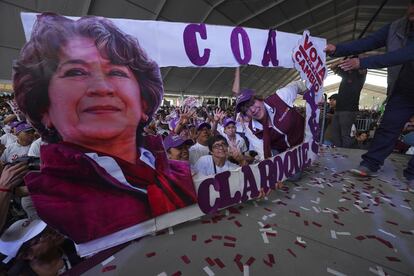 MORENA political party gubernatorial candidate Delfina Gomez, right, poses with a cardboard cutout with her image during a campaign rally in Valle de Chalco, Mexico