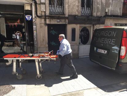 Un trabajador de la funeraria llega al lugar para recoger el cadáver.