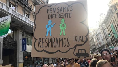 Sign reads: “We think differently, we breathe the same.”