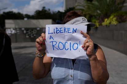 A protester holds a sign that reads in Spanish "Release Rocio!," referring to arrested activist Human Rights lawyer and activist Rocio San Miguel, on the sidelines of a press conference about her detention the previous week, outside office of the UN Development Program (PNUD) in Caracas, Venezuela, Wednesday, Feb 14, 2024