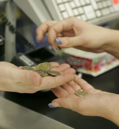 Una mujer paga la compra en el supermercado