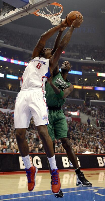 Garnett trata de impedir la canasta de DeAndre Jordan.