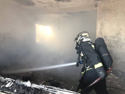 Los bomberos trabajan en el interior de la vivienda cuyo incendio costó la vida a un hombre de 88 años