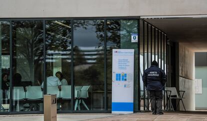 A la derecha, sanitarios a la espera de pacientes en el hospital Enfermera Isabel Zendal. En la puerta, el vigilante de seguridad. 