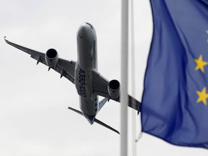 An aircraft flies past the EU flag at the Paris Air Show.