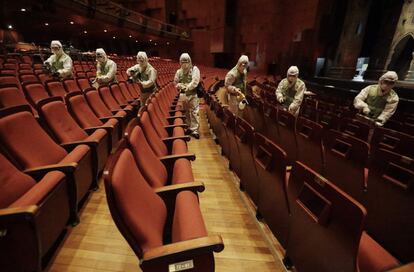 Workers wearing protective gears, spray antiseptic solution as a precaution against the spread of MERS, Middle East Respiratory Syndrome, virus at the Sejong Culture Center in Seoul, South Korea, Tuesday, June 16, 2015. The outbreak of the poorly understood disease has caused widespread fear in South Korea and criticism that health workers and the government failed to initially recognize and quickly contain it. (AP Photo/Ahn Young-joon)