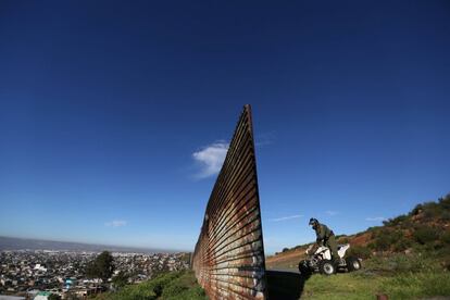 Un miembro estadounidense de la patrulla fronteriza inspecciona el área donde se interrumpe la valla de la frontera que separa México y Estados Unidos, a las afueras de Tijuana (México).