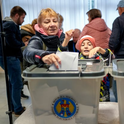 Women cast their vote in Chisinau, Moldova, Sunday, Oct. 20, 2024, during a presidential election and a referendum on whether to enshrine in the Constitution the country's path to European Union membership. (AP Photo/Vadim Ghirda)