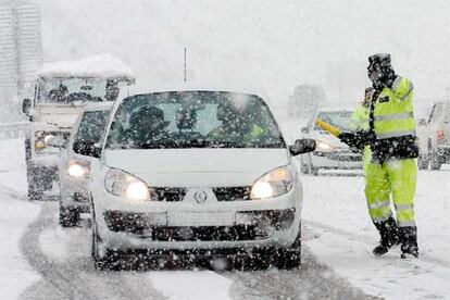 Efectivos de la Guardia Civil controlan el paso de vehículos en la A-15 que une Pamplona con San Sebastián y que este miércoles ha sufrido varios cierres temporales debido al temporal de nieve.