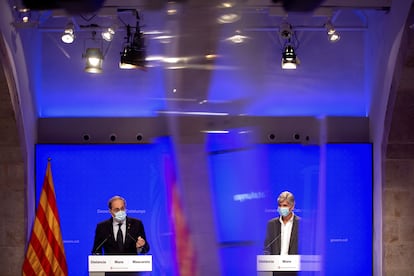 El presidente de la Generalitat, Quim Torra, junto al director de Salud Pública, Josep Maria Argimon (d), en una rueda de prensa